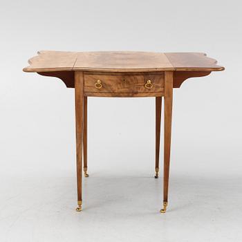 A mahogany drop leaf table from around the year 1900.