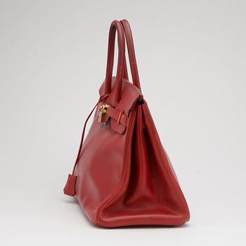 HERMÈS, a raspberry red leather "Birkin 35" bag.