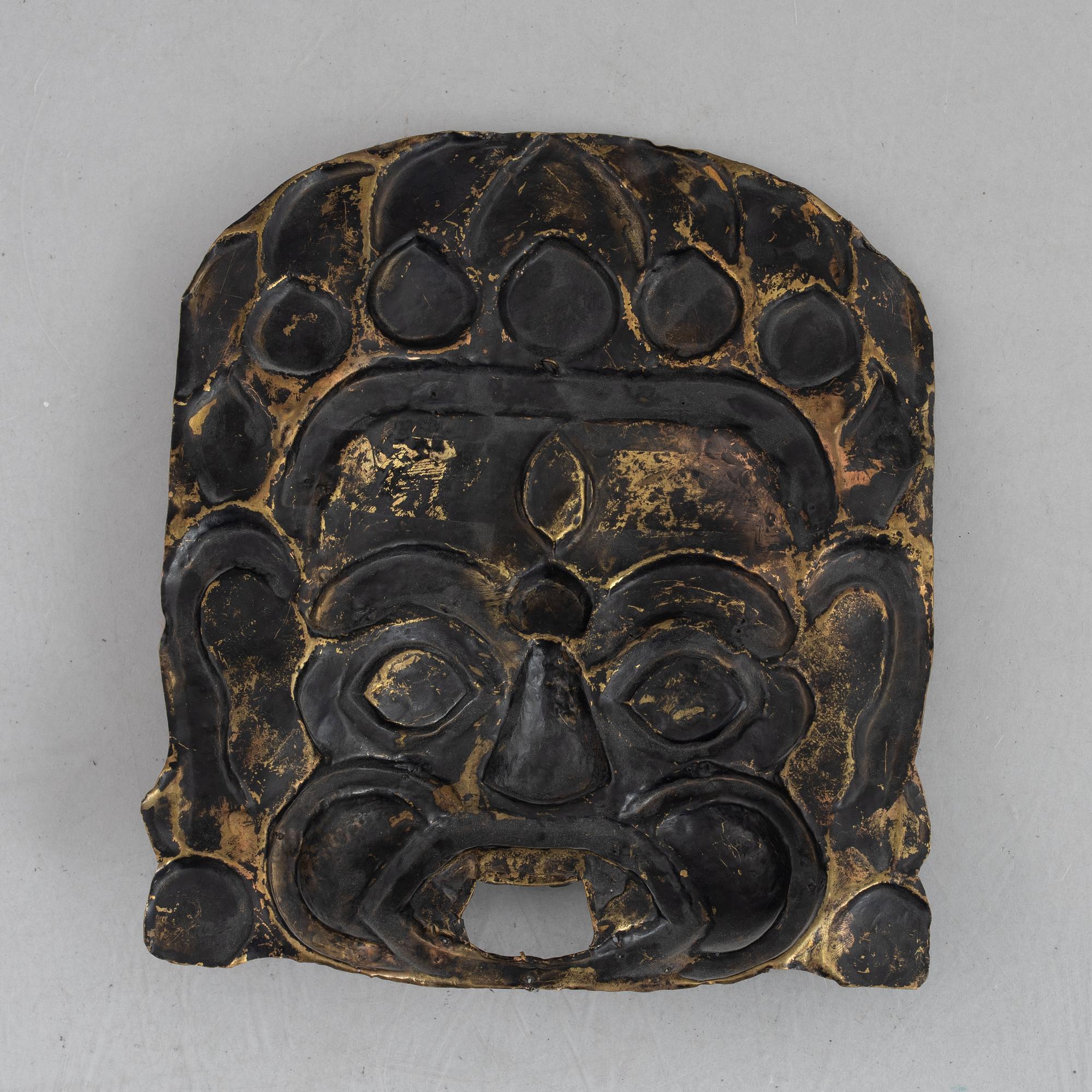 A stone inlay mask, Nepal, early 20th century.