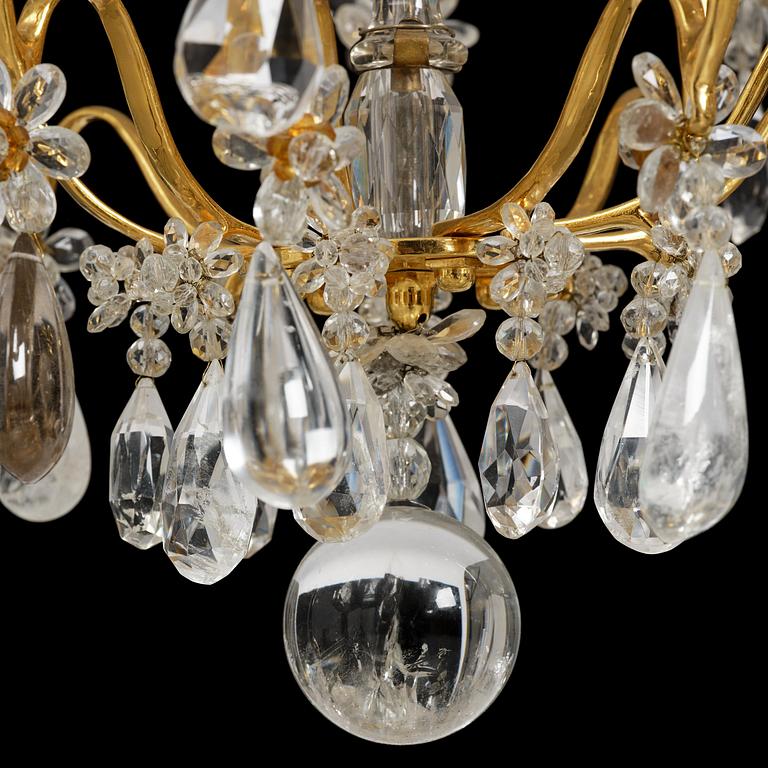 A near pair of Franch Louis-XV-style nine-branch gilt bronze and rock crystal chandeliers, later part 19th century.