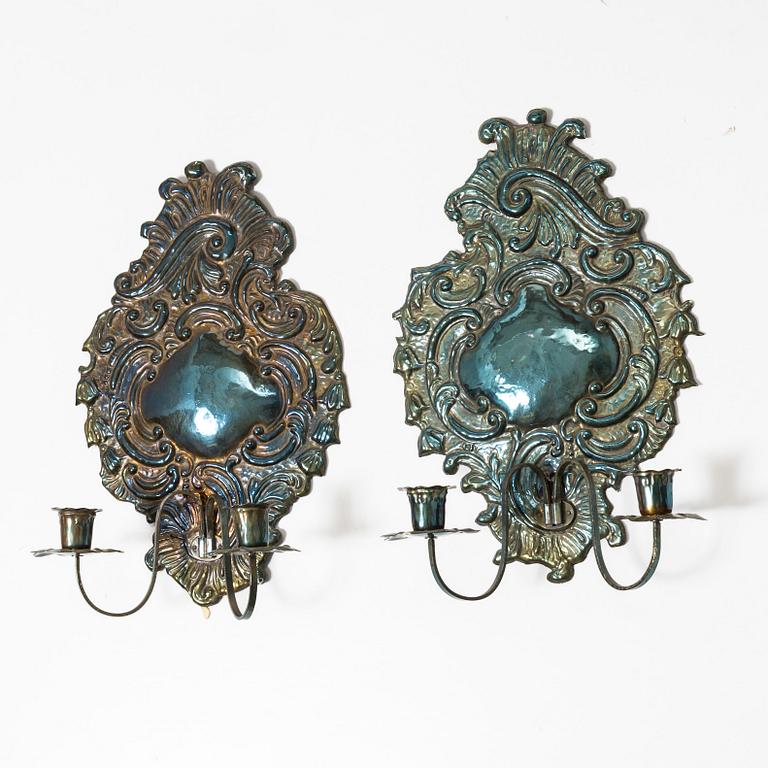 A pair of Rococo-style silver-plate sconces, early 20th century.