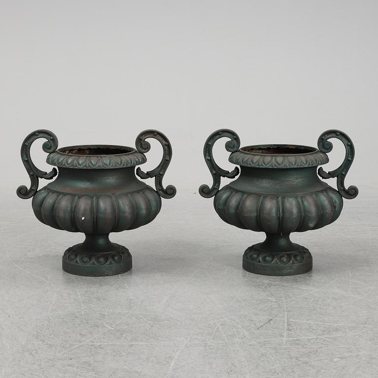 A 20th Century pair of cast iron flower pots.