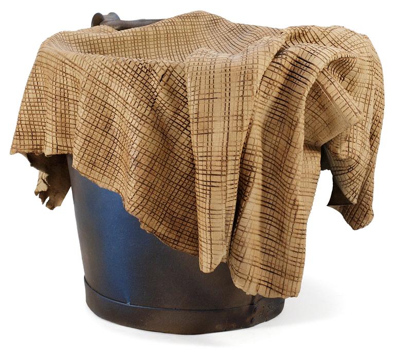 An Ingrid Herrlin stoneware bucket with a cleaning-cloth.