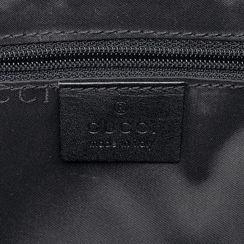 Gucci, a black leather handbag.
