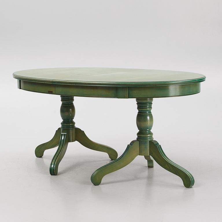 A dining table with eight chairs, Grange, France, late 20th century.