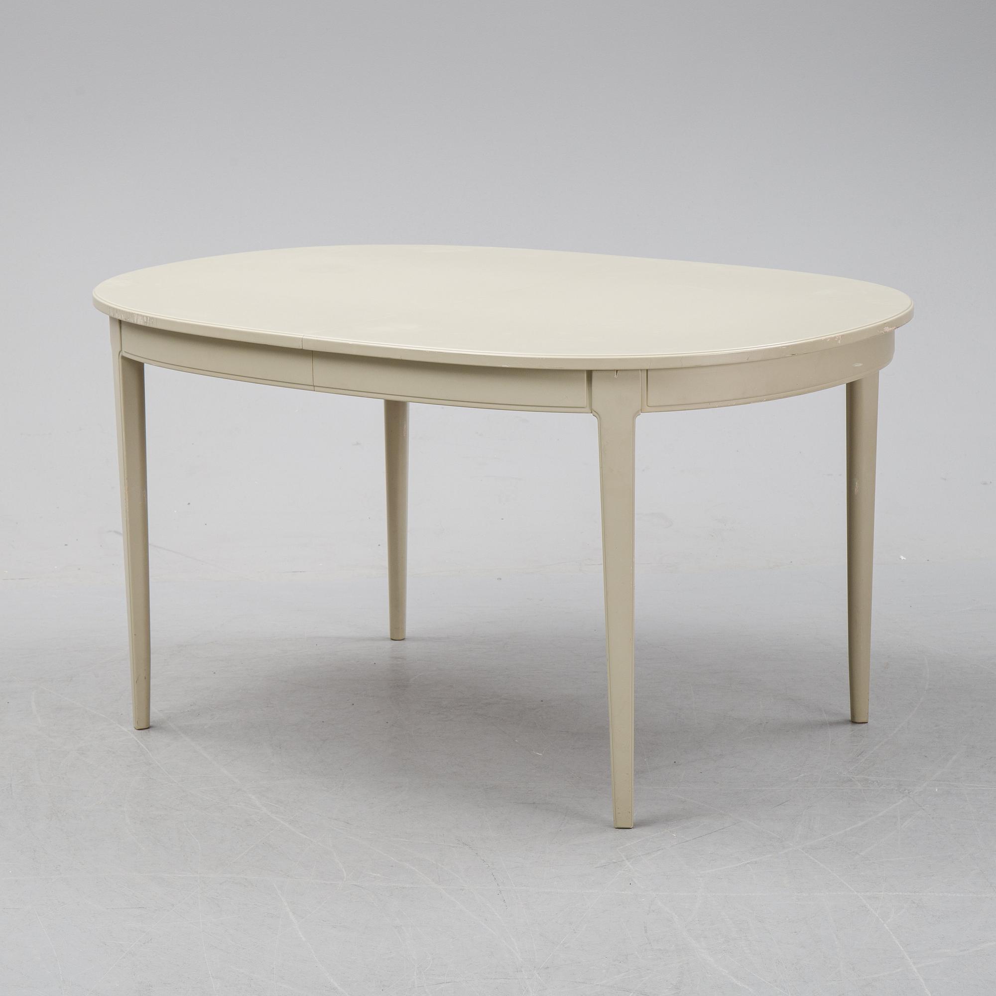 A dining table with two armchairs and six chairs by Carl Malmsten for Bodafors.