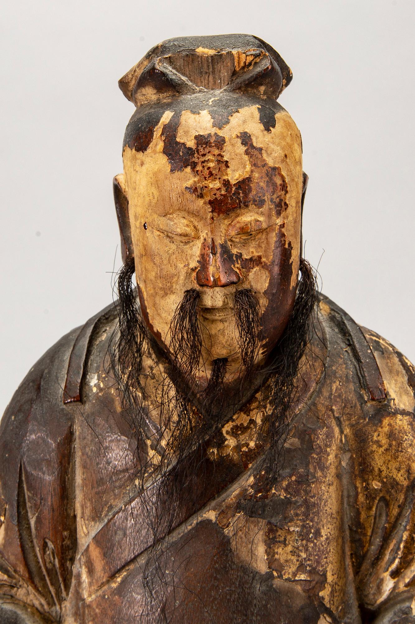 A Chinese late Qing painted wooden sculpture.