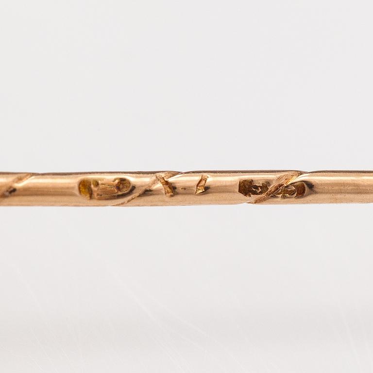 A 14K gold tiepin with a aquamarine.