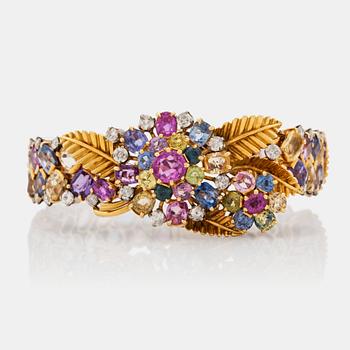 624. A 1940's multi coloured sapphire and brilliant cut diamond bracelet that can be worn as a clip.
