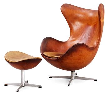 52. An Arne Jacobsen brown leather 'Egg chair' with ottoman, by Fritz Hansen, Denmark 1963.