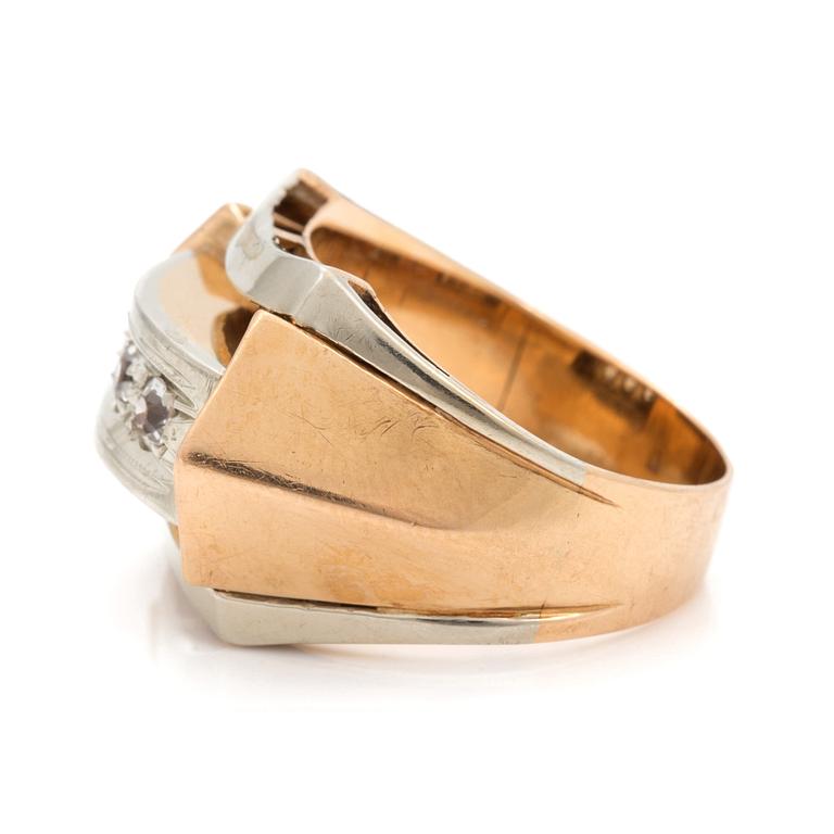 A ring set with three faceted, white stones.