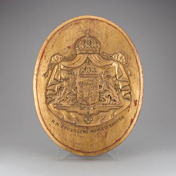 SKYLT, märkt H.M. KONUNGENS HOVLEVERANTÖR, 1900-tal.