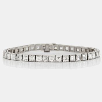 956. A platinum bracelet set with carré cut diamonds.