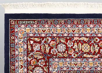 A signed Hereke carpet, ca 340 x 246 cm.