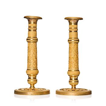 A pair of French gilded Empire candlesticks, early 19th century.