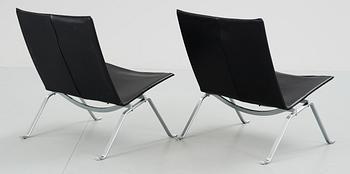 A pair of Poul Kjaerholm 'PK-22' steel and black leather easy chairs, Fritz Hansen, Denmark 1992.