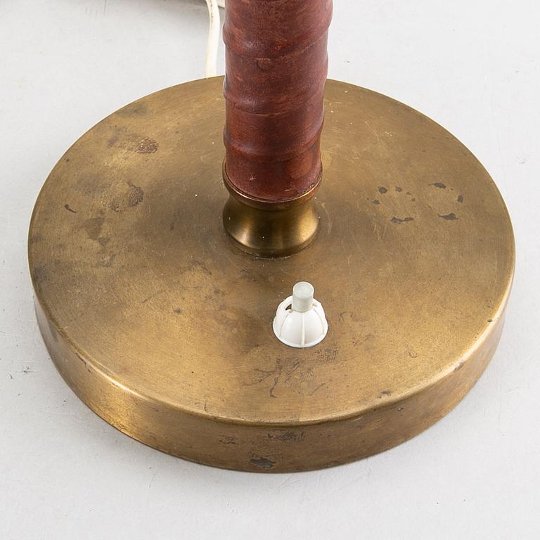 A Swedish brass and leather lamp around 1950.