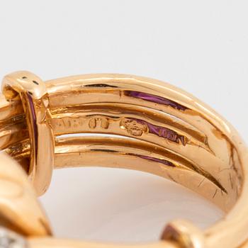 A WA Bolin ring in 18K gold set with a cabochon-cut amethyst and round brilliant-cut diamonds.