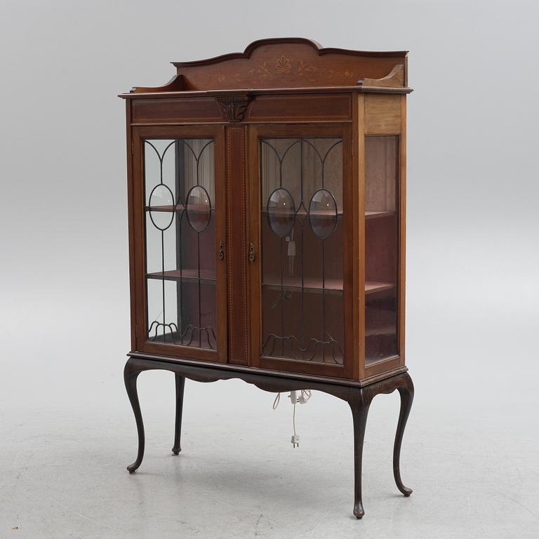 A display cabinet, England, early 20th century.