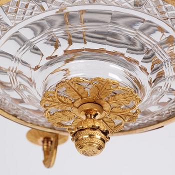 An Empire cut glass and gilded bronze six-light hanging lamp in the manner of Alexandre Guérin.