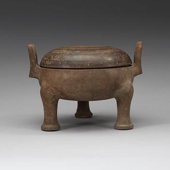 A pottery tripod censer, Han dynasty (206 B.C. -220 A.D.).