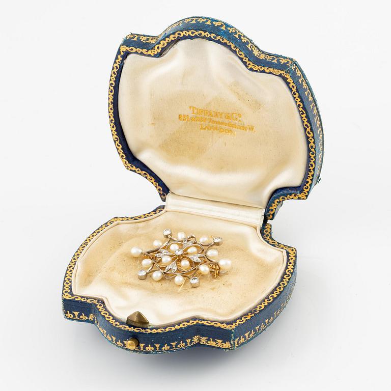 A brooch in 18K gold with pearls and round brilliant-cut and eight-cut diamonds.