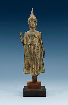 1292. A slender bronze figure of Buddha, holding the left hand in Abhaya muddra, Thailand, 18/19th Century.