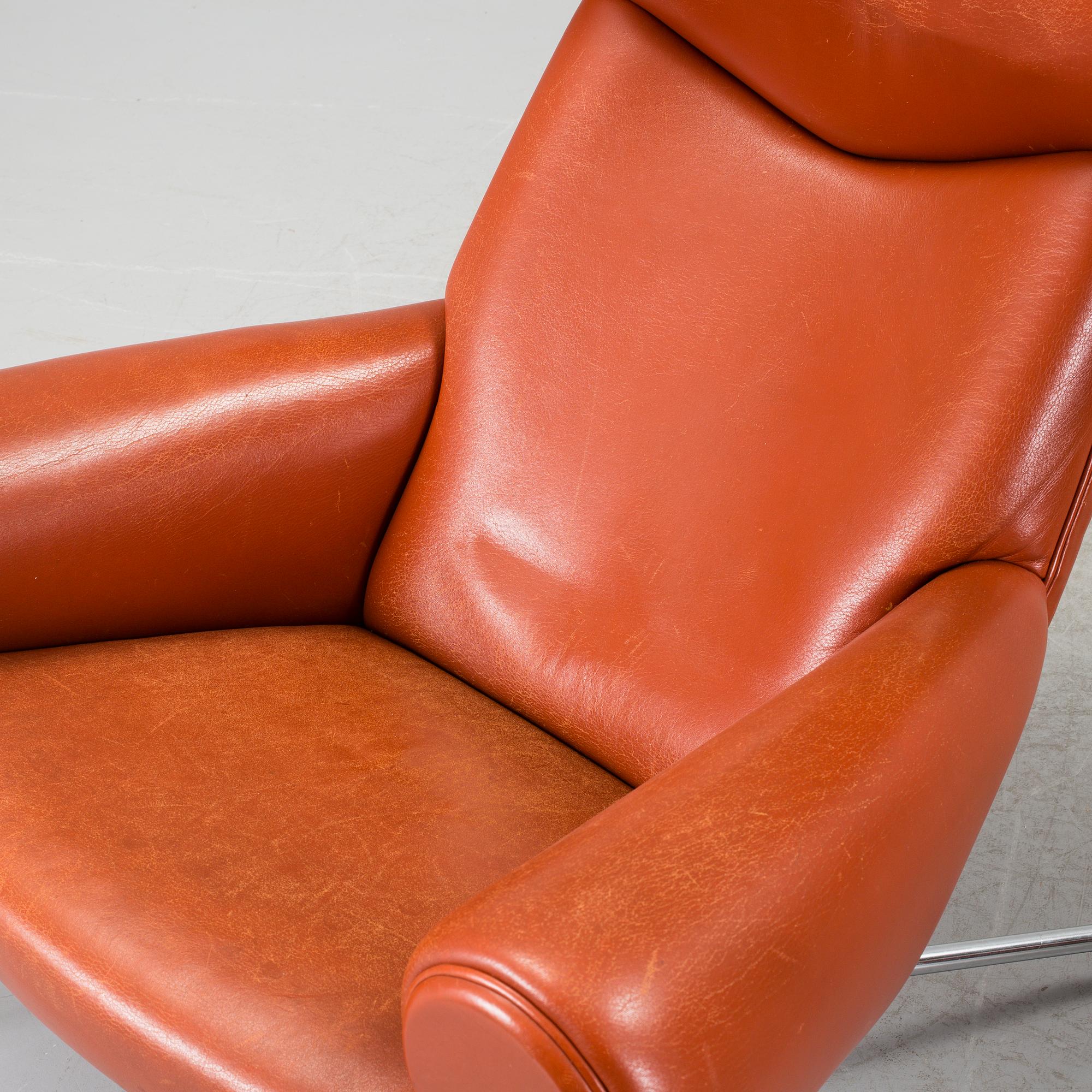 An "Ox-Chair" and foot stool by Hans J Wegner for Erik Jorgensen, Denmark.