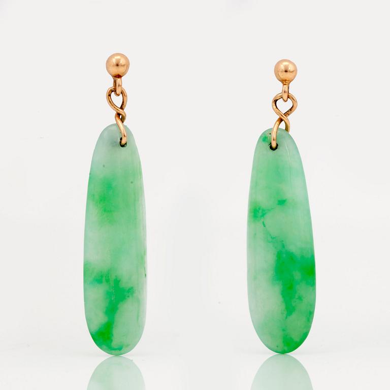 A carved jadeite pendant and earrings.
