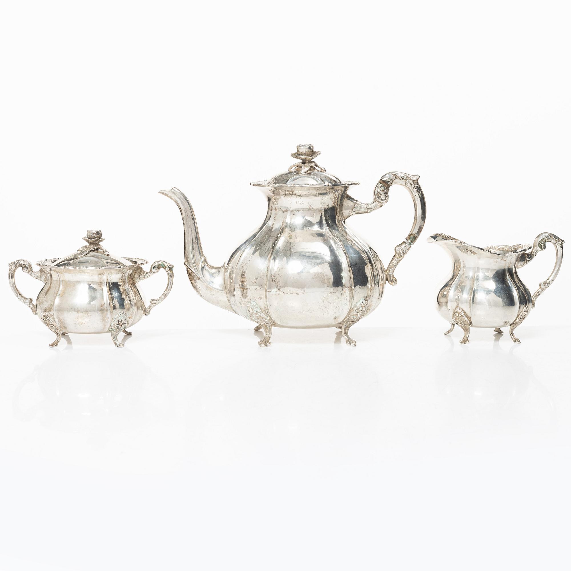 A Rococo style silver coffee pot, cream jug and sugar bowl, 20th century, Swedish import mark.