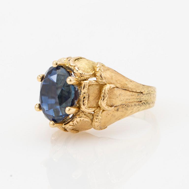 Ring, 18k gold with blue stone, possibly sapphire.
