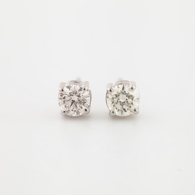 A pair of brilliant cut diamond earrings.