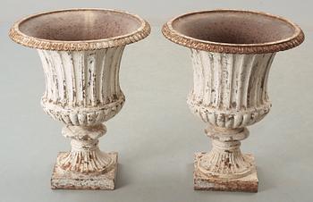 A pair of English 1860's iron garden urns.