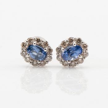 Earrings in 18K white gold with oval faceted sapphires and round brilliant-cut diamonds.