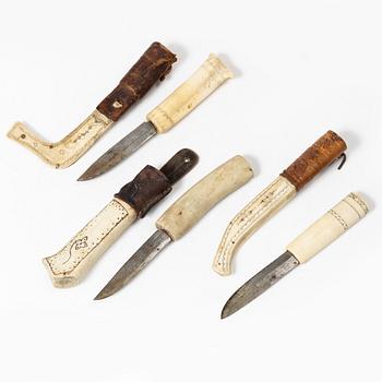 Six knives, and a cup.
