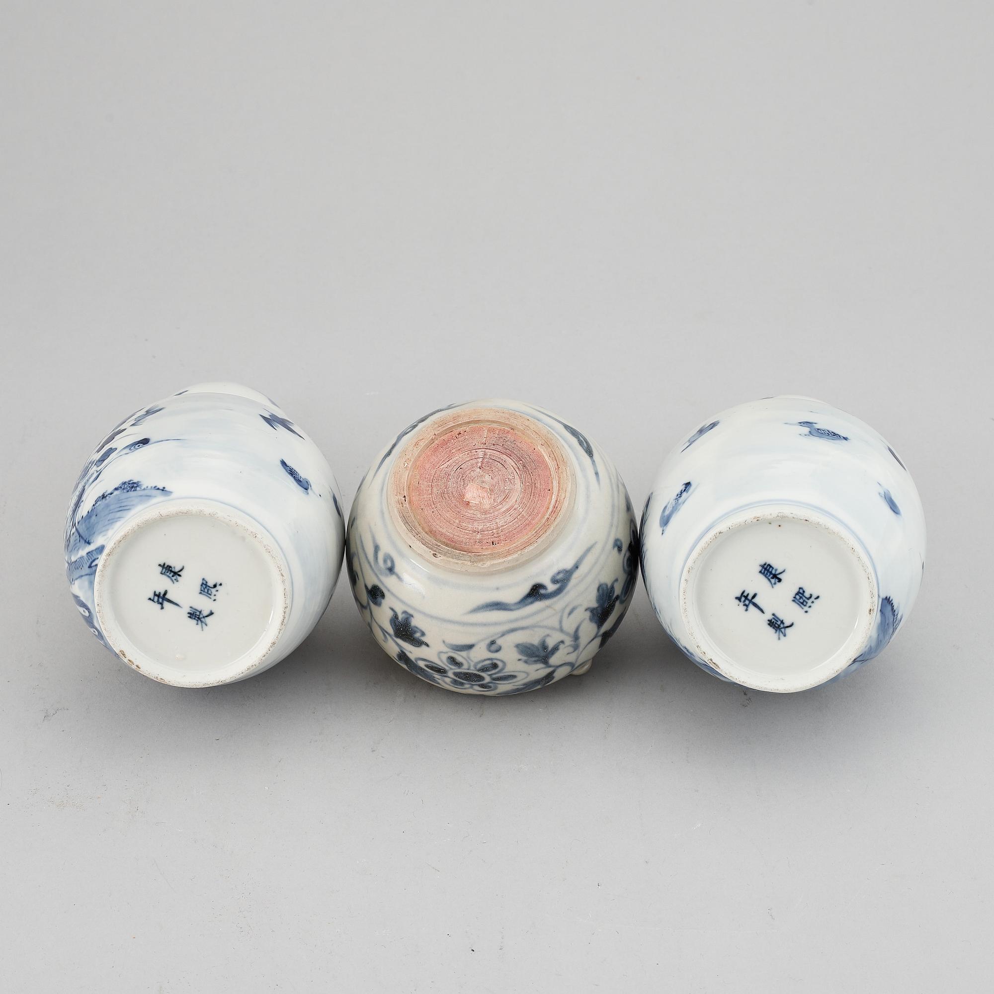 A pair of blue and white 'double gourd' vases, Qing dynasty, late 19th century, and a ceramic jar, south east asian.