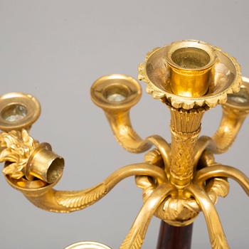 A pair of mid 19th century late Empire bronze and marble candelabra.