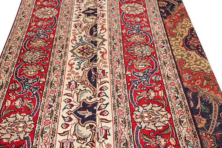 A Tabriz carpet, c. 345 x 255 cm.