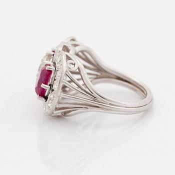 An 18K white gold ring set with faceted rubies and a round brilliant-cut diamond and eight-cut diamonds.