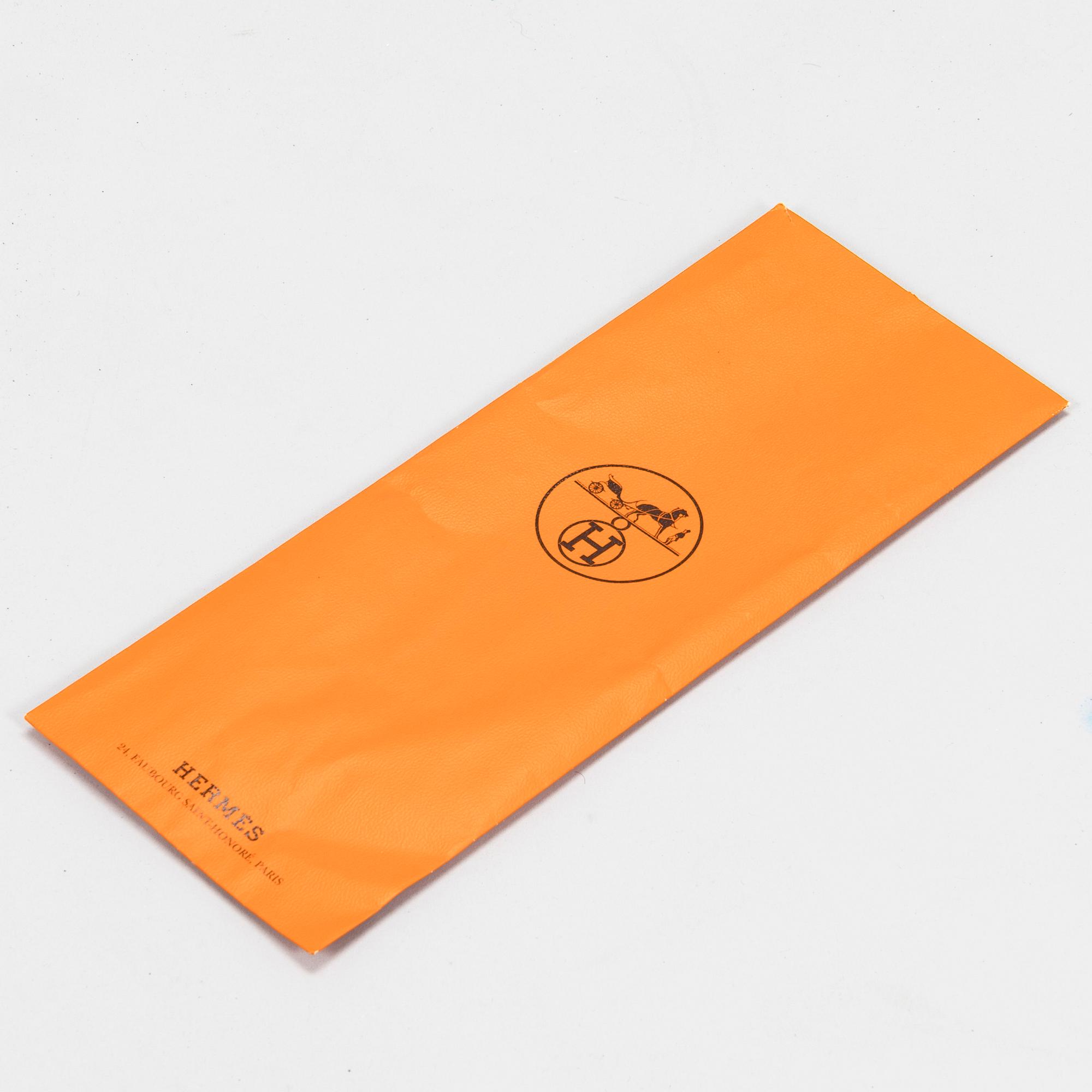 Hermès, a 'Les Rubans du Cheval' silk scarf.