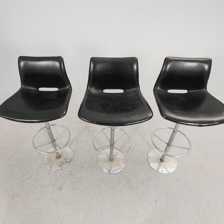 A set of three late 20th century metal and leather bar stools.