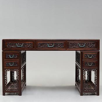 A carved hardwood desk, late Qing dynasty, circa 1900.