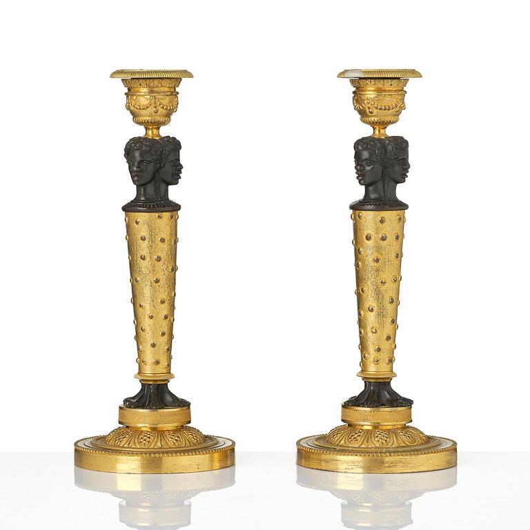 A pair of Napoleon III gilt and patinated bronze candlesticks, later part 19th century.