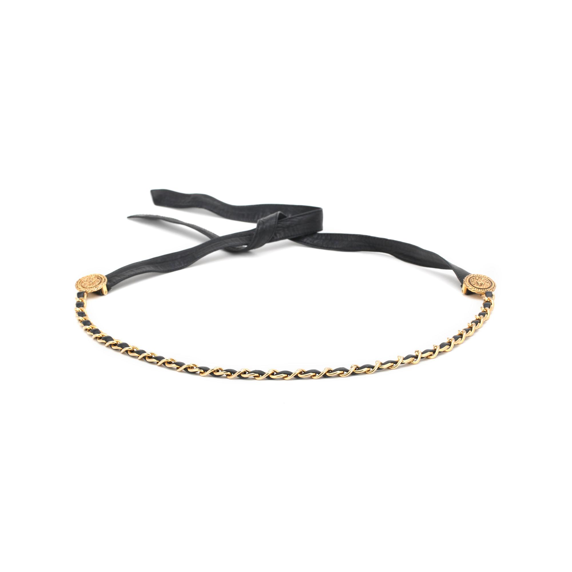 CHANEL, a black leather belt with gold colored metal chain.