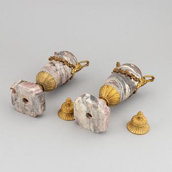 A pair of marble urns with bronze mountings from around year 1900.