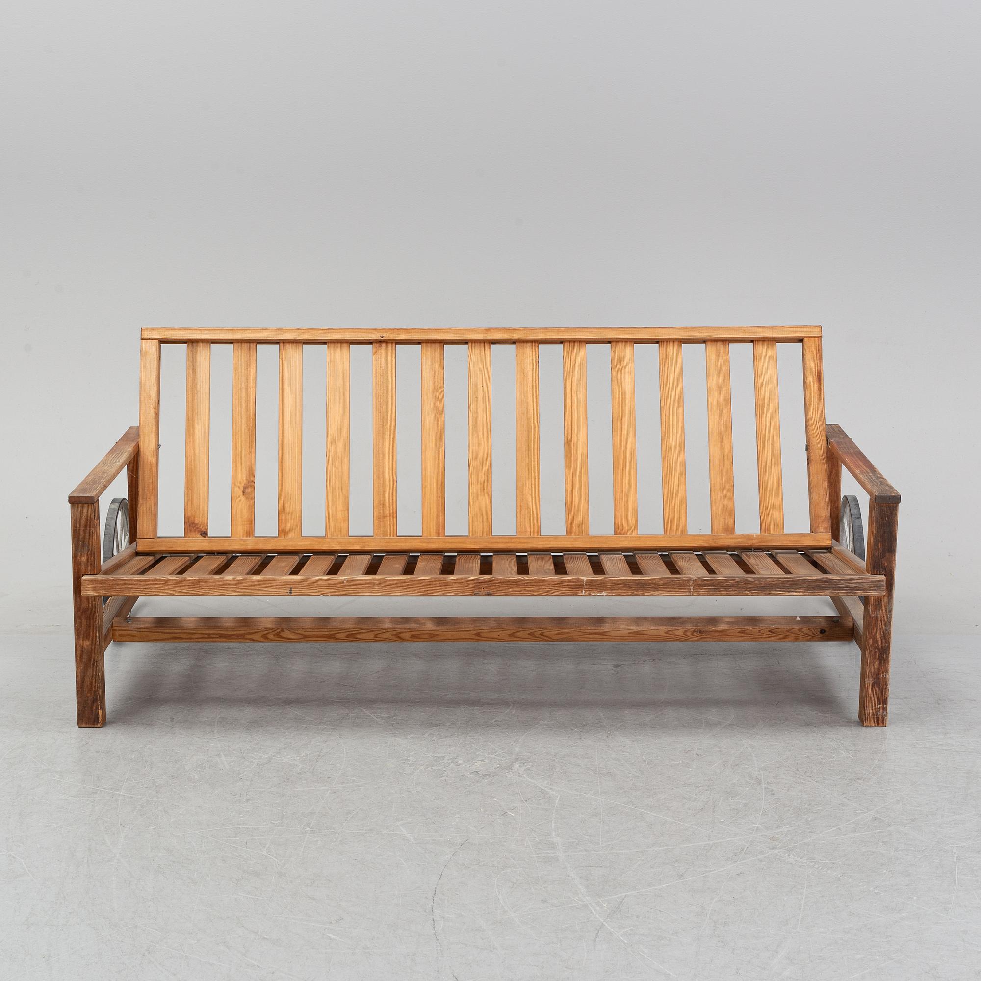 A stained pine garden sofa by Elsa Stackelberg.