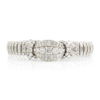 A platinum bracelet set with step-cut and brilliant-cut diamonds.