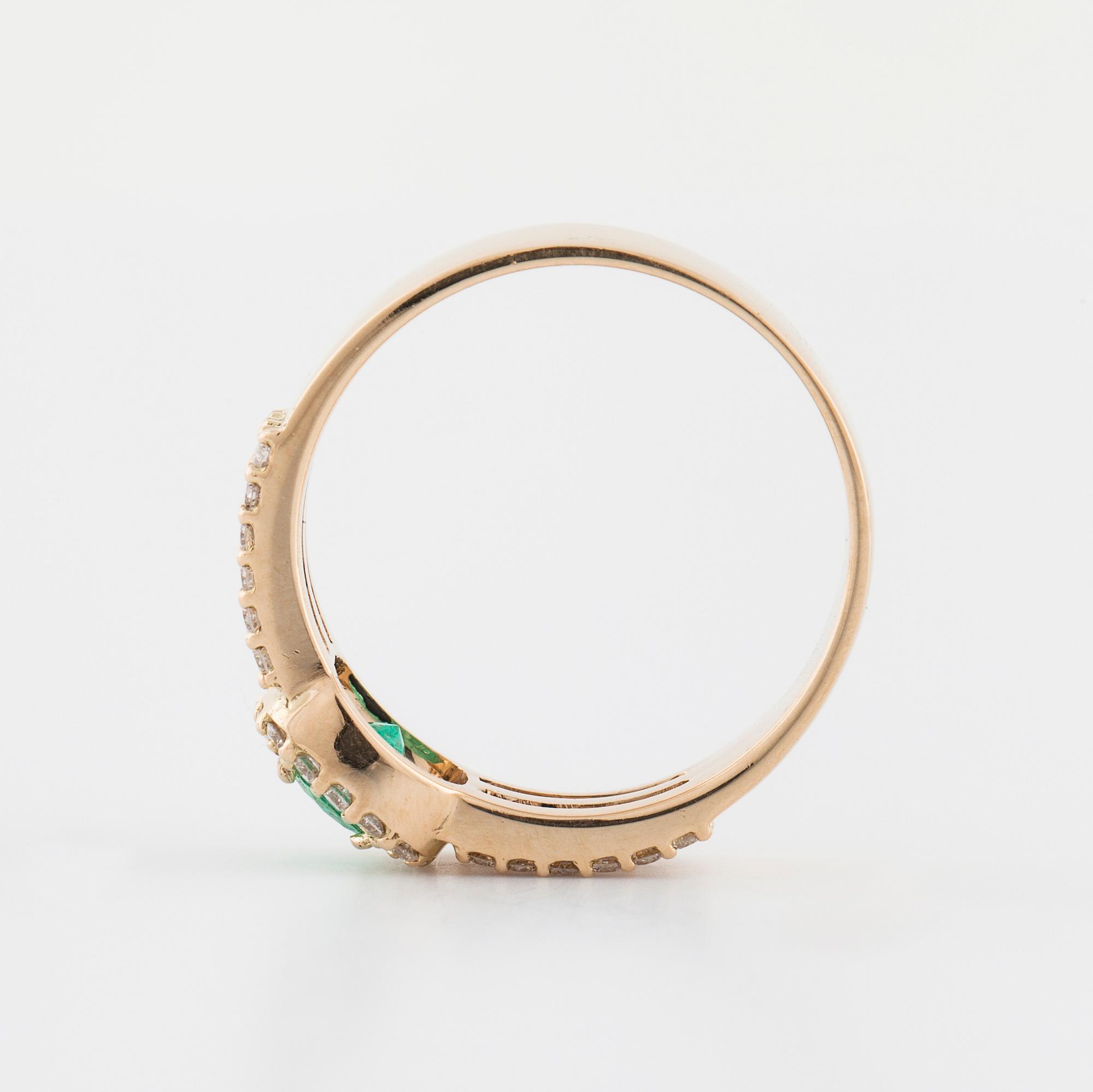 A faceted emerald and brilliant cut diamond ring.