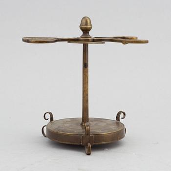 A 18th Century brass candle holder.