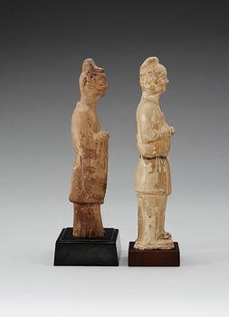 Two glazed pottery figurines of standing officials, with traces of paint, Tang dynasty (618-907).
